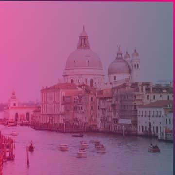 A view of the Grand Canal in Venice with boats on the water and historic buildings, including domes, under a pink overlay—capturing a picturesque moment reminiscent of Memcyco at ConnectUP 2026.