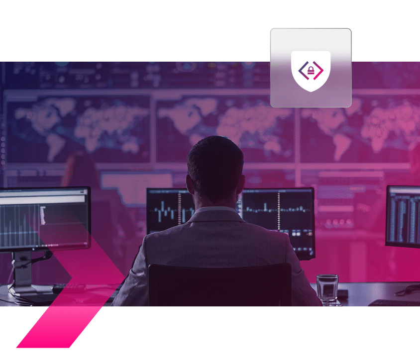 Person sits at a desk with multiple monitors displaying data and world maps, monitoring for any sign of remote desktop takeover; security-themed logo appears above.