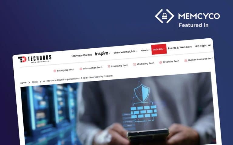 A computer screen displays a TechDogs article titled “AI Has Made Digital Impersonation A Real-Time Security Problem” on cybersecurity, with a blurred figure using a smartphone and floating security icons in the foreground.