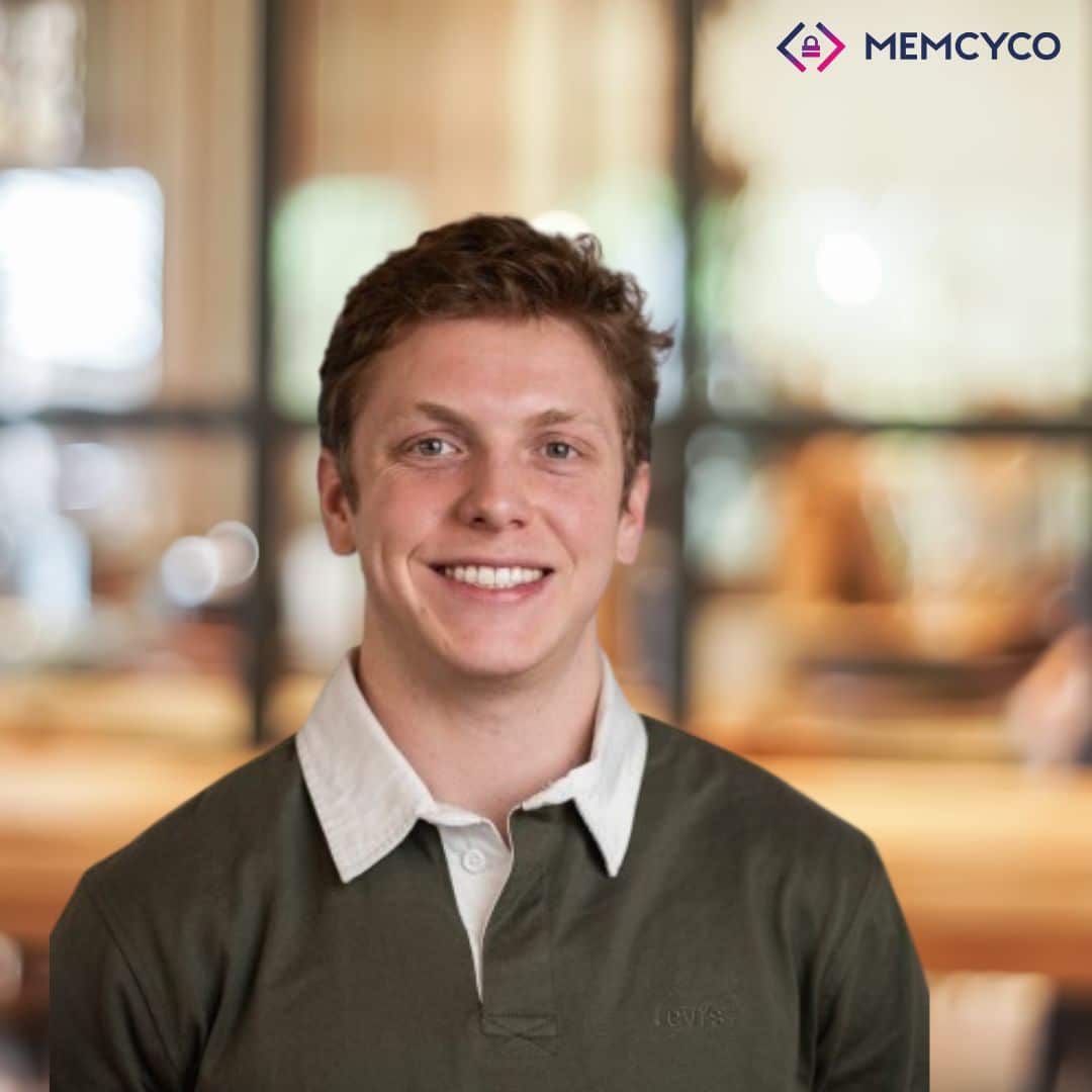 A smiling man in a green collared shirt stands indoors with a blurred office background; the MEMCYCO logo appears in the top right corner, highlighting Memcyco at IAFCI Conference Nashville.